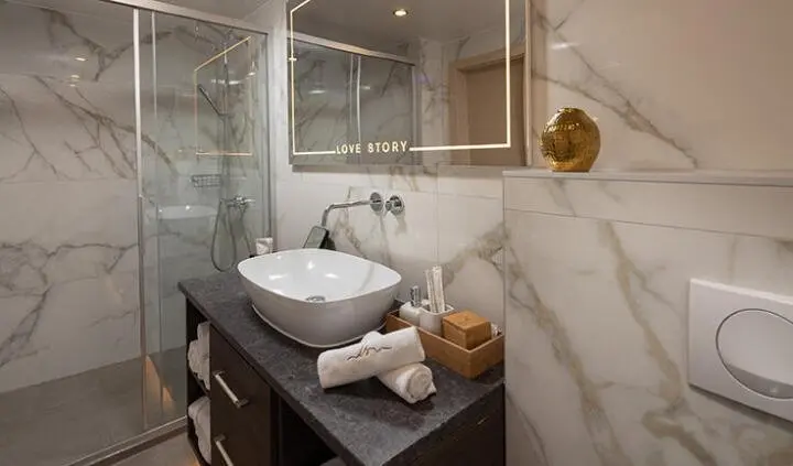 Master cabin with king bed, marble ensuite, and modern bathroom fixtures