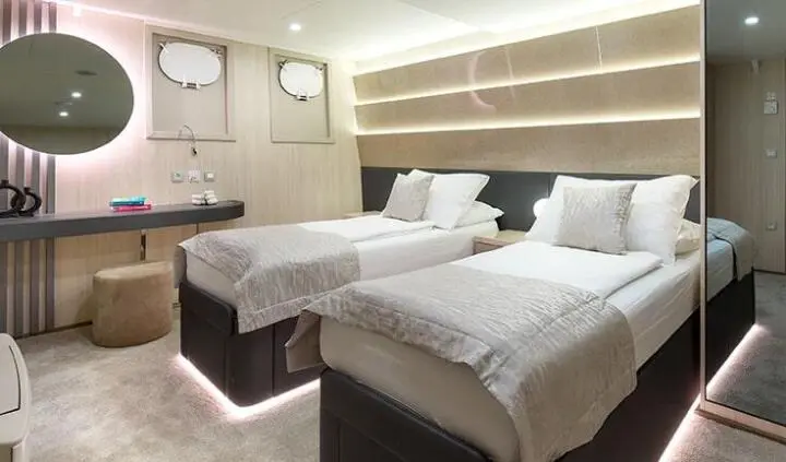 Twin cabin aboard Cristal yacht with two single beds and ensuite.