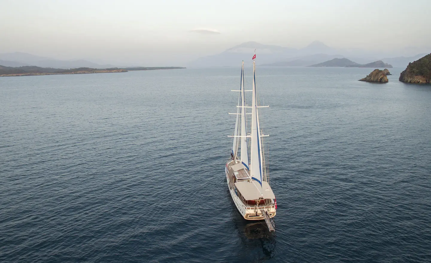 Luxurious two-masted yacht Kayhan 5 seen at sunset on the sea