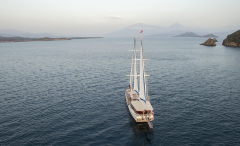 Luxurious two-masted yacht Kayhan 5 seen at sunset on the sea