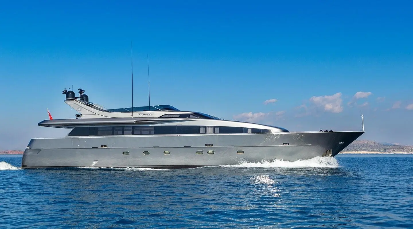 Side view of luxury yacht Summer Fun anchored on calm blue water under clear sky