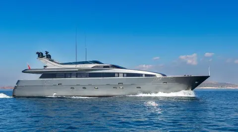 Side view of luxury yacht Summer Fun anchored on calm blue water under clear sky