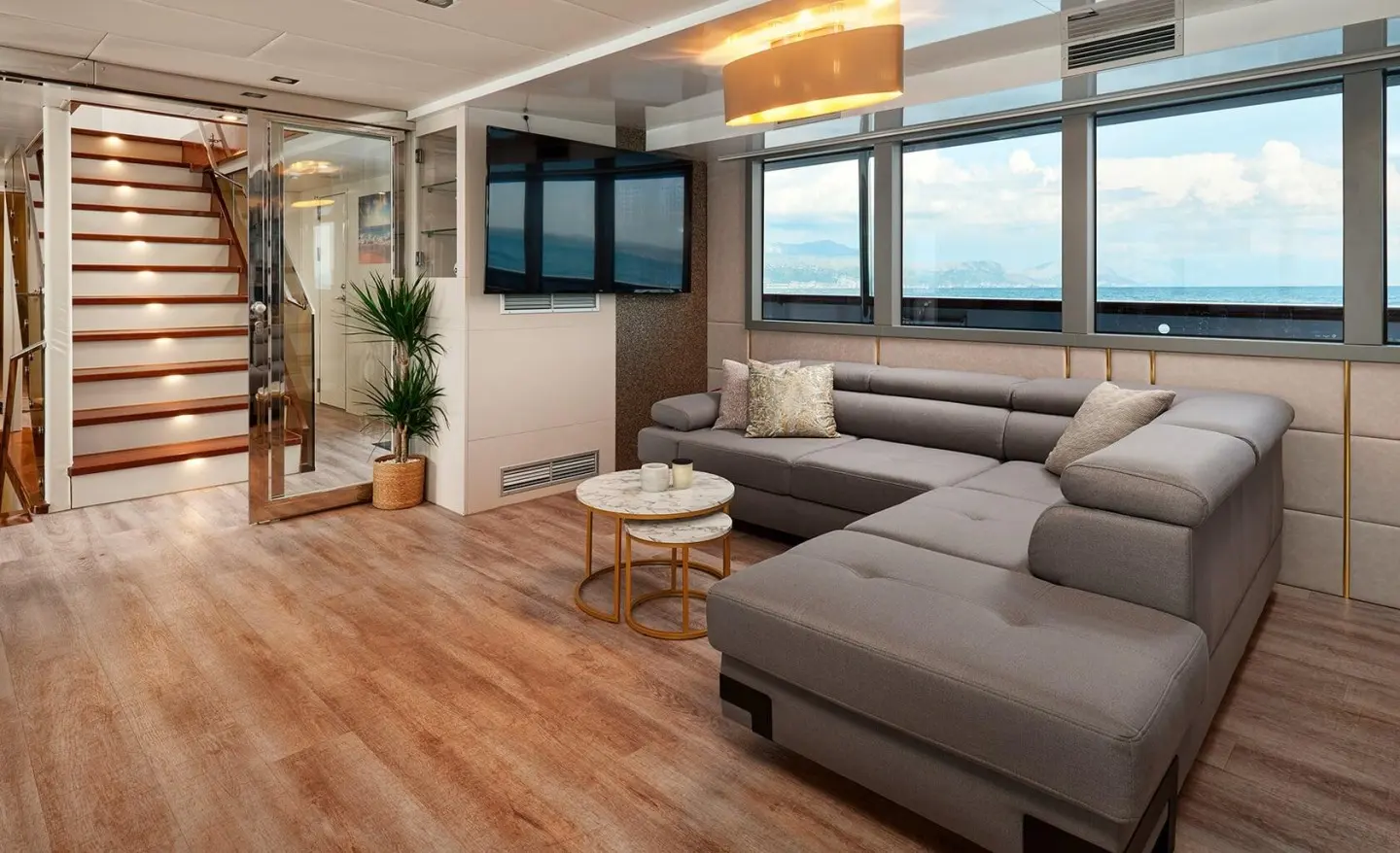Ohana yacht interior with a modern living area and large windows showing the sea