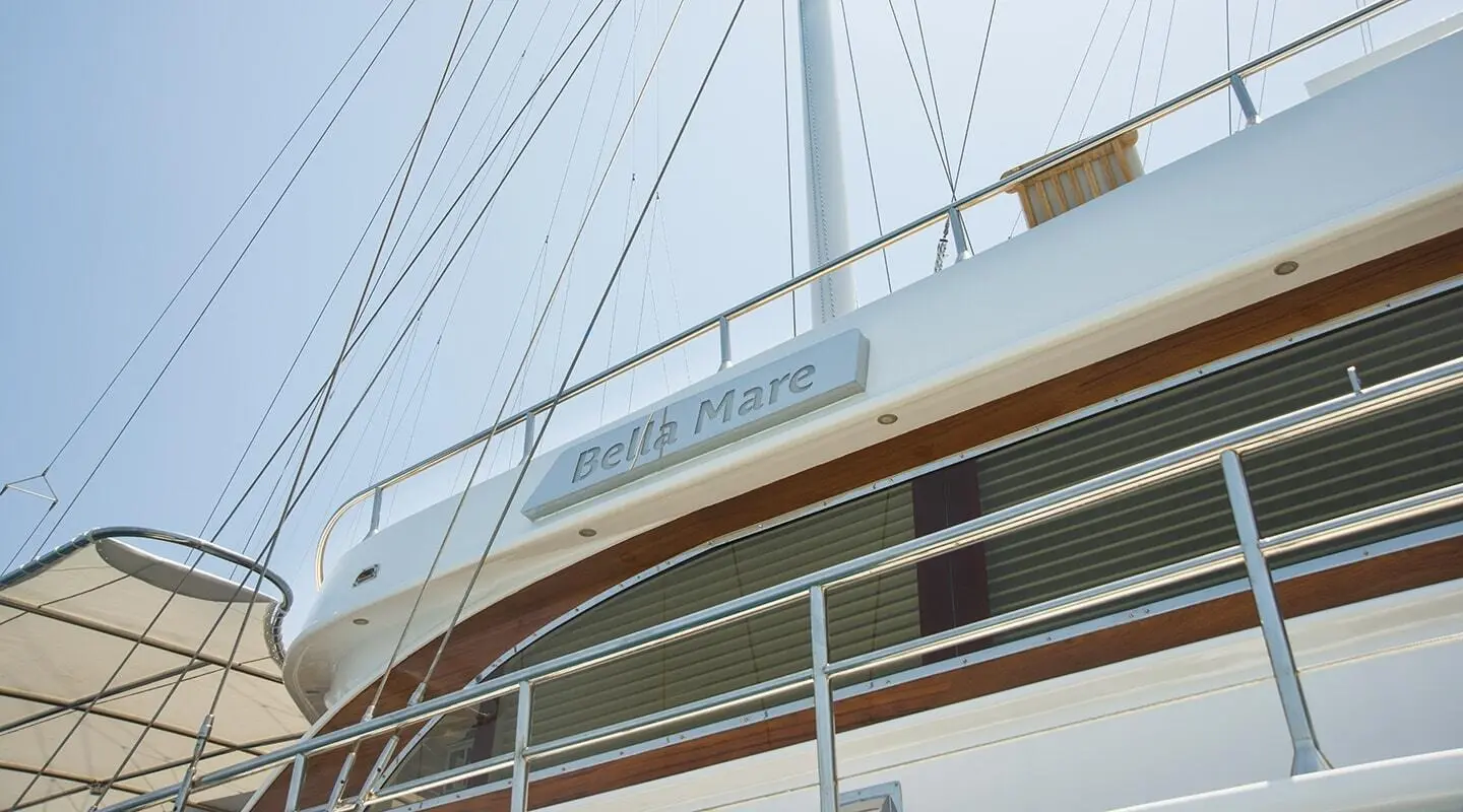 Bella Mare yacht with a wooden hull and white superstructure at sea