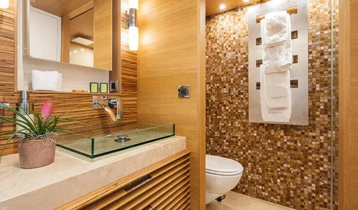 Master cabin with king bed, ensuite bathroom, wood paneling, warm lighting