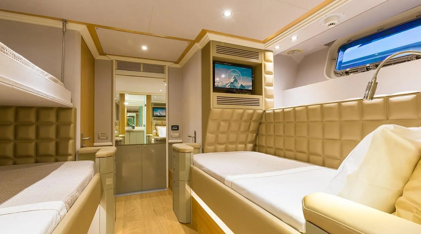 Interior of luxury yacht Aquarella with a large bed, wooden panels, and ambient lighting
