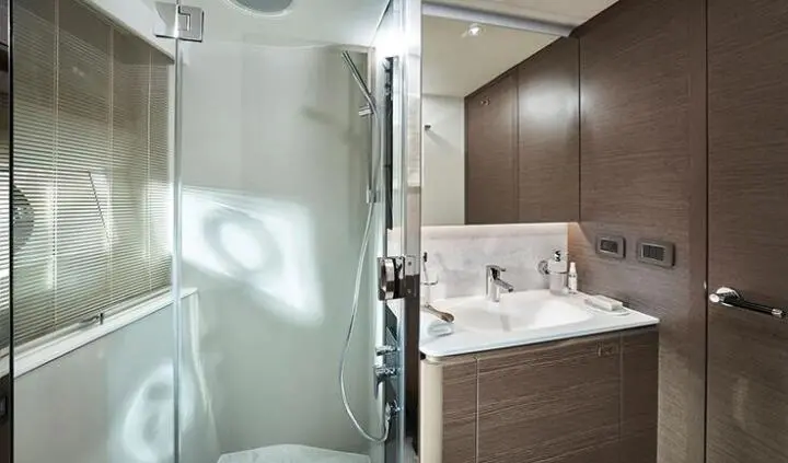 Elizabeth yacht master cabin with king bed, ensuite, wood cabinetry, and glass shower