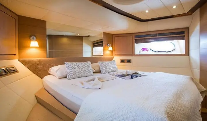 Luxurious yacht cabin with two large beds, plush white linens, and soft ambient lighting
