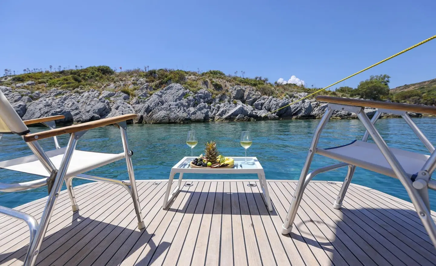 Gazella gulet yacht deck with sun loungers on swim platform and clear blue sea