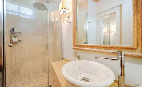 Cobra King yacht interior bathroom with sink and mirror, warm lighting