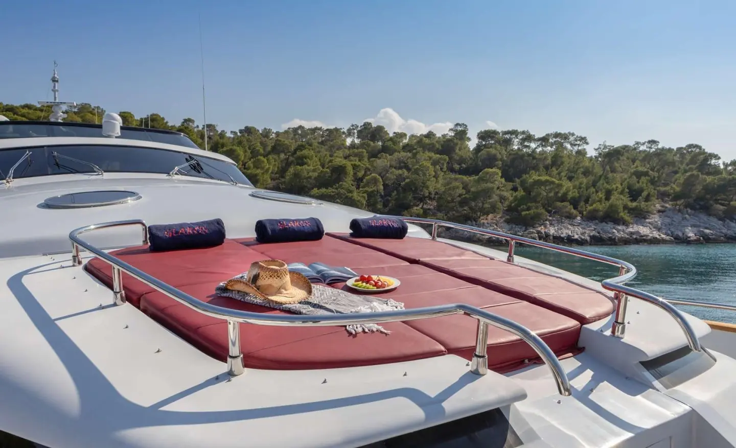 Glaros yacht bow deck with sun loungers and red deck accents