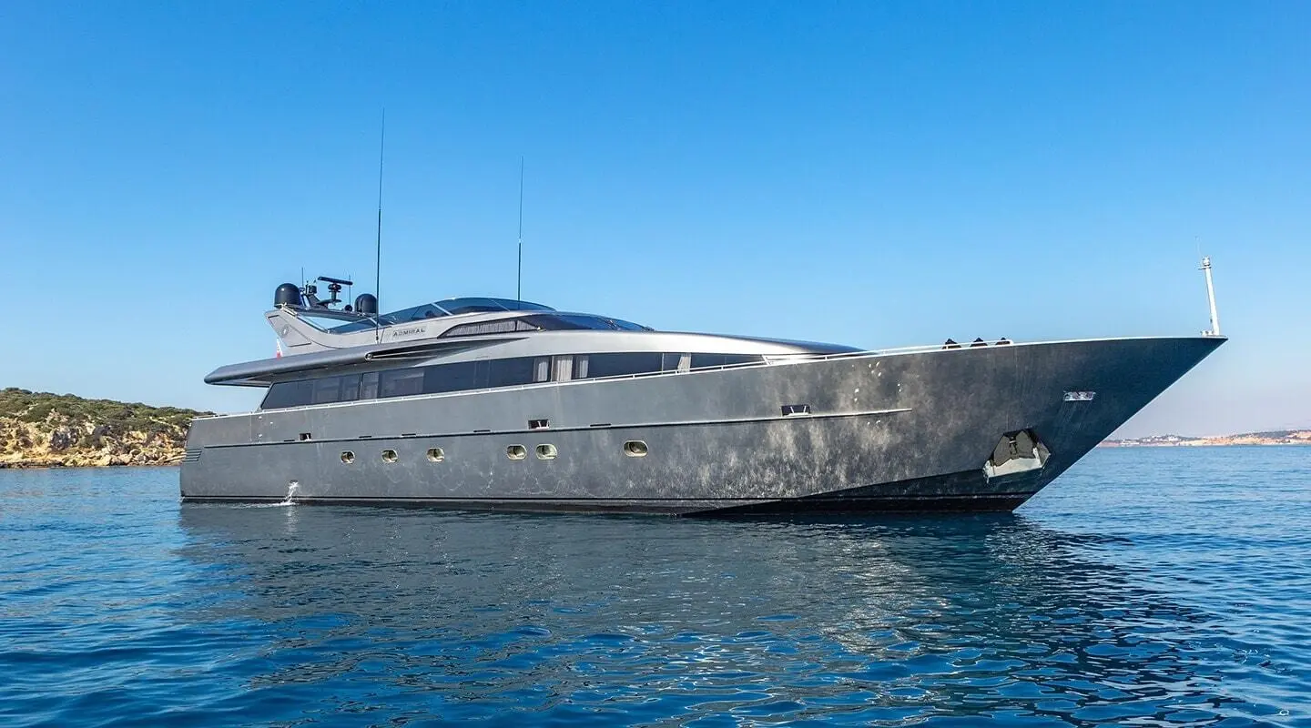 Luxurious motor yacht named Summer Fun docked beside calm blue water