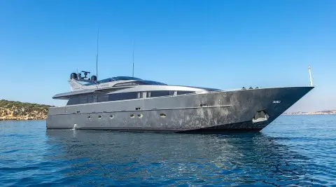 Luxurious motor yacht named Summer Fun docked beside calm blue water