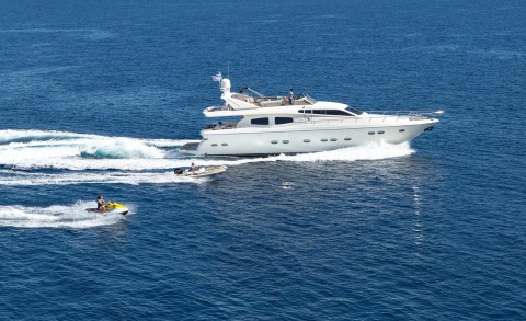 Amoraki yacht cruising on open sea with deck aft and passengers visible