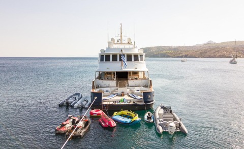 Wind Of Fortune yacht anchored with multiple tender boats and water toys nearby