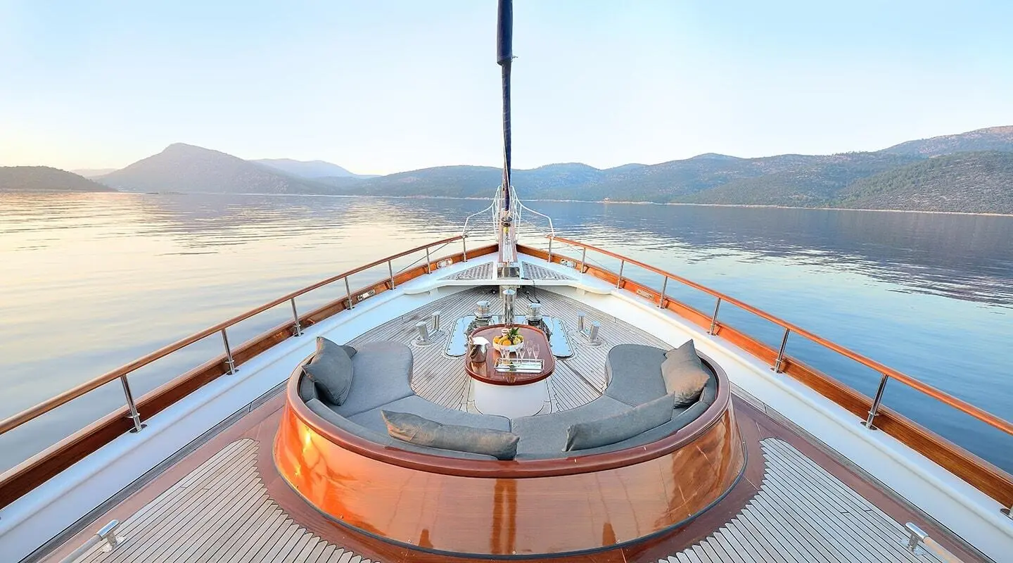 Bow deck of Cobra King yacht with polished wood surface and lifebuoy rings