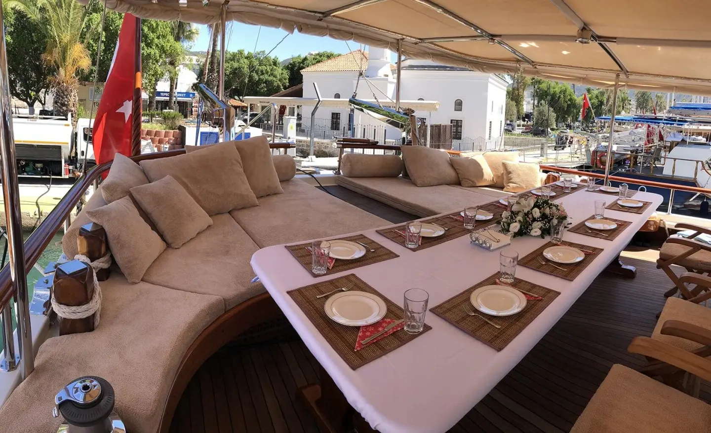 Enderim A yacht during sunset with a curved seating area and dining setup