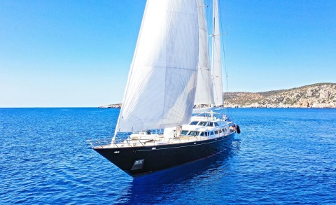 Sailing yacht Tamarita on blue sea with sails up