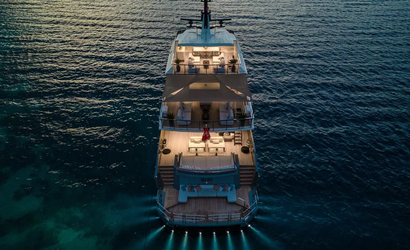 Illusion II yacht at sea during sunset, two-deck vessel seen from above