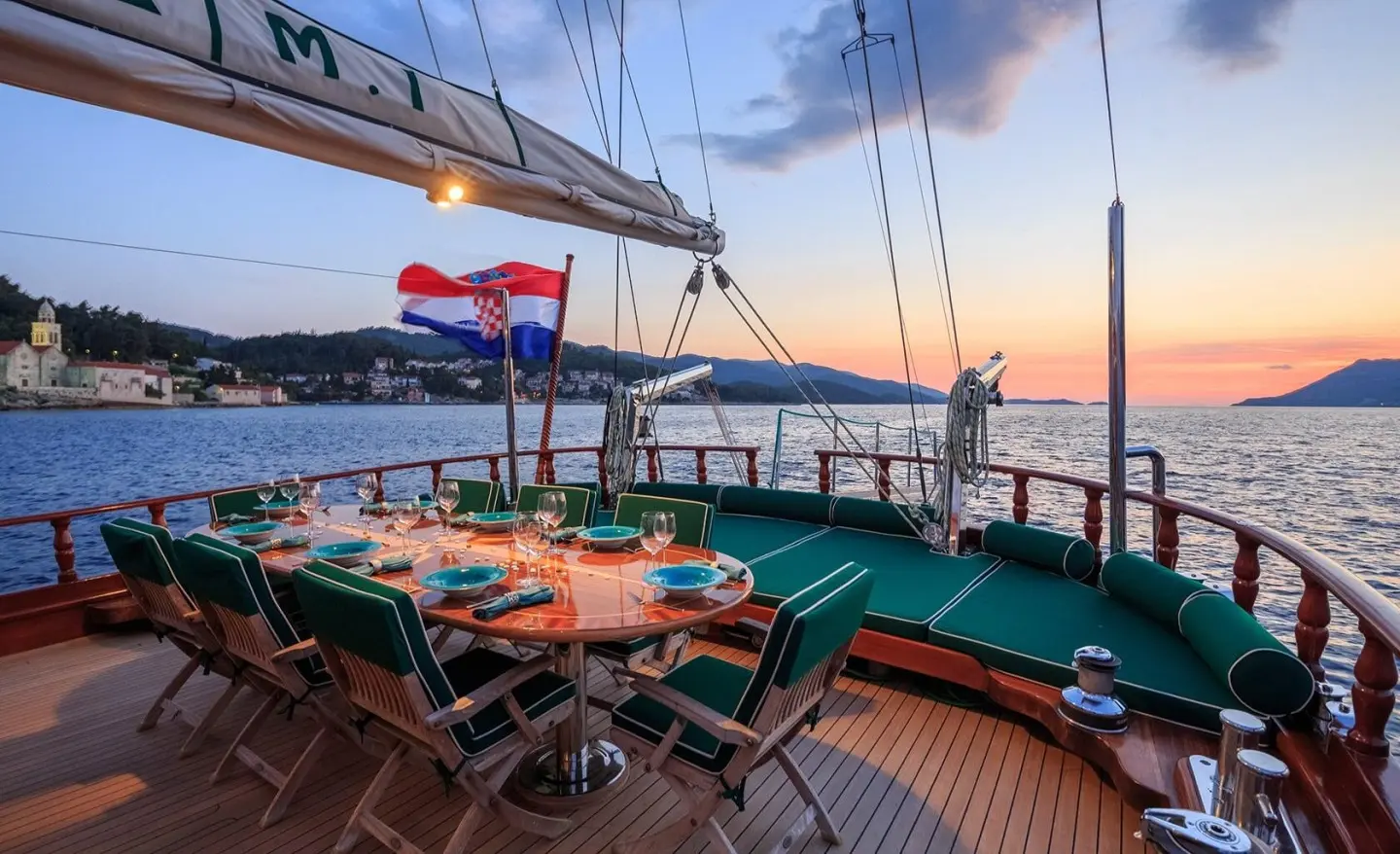 Carpe Diem 7 luxury yacht deck at sunset with tables and chairs