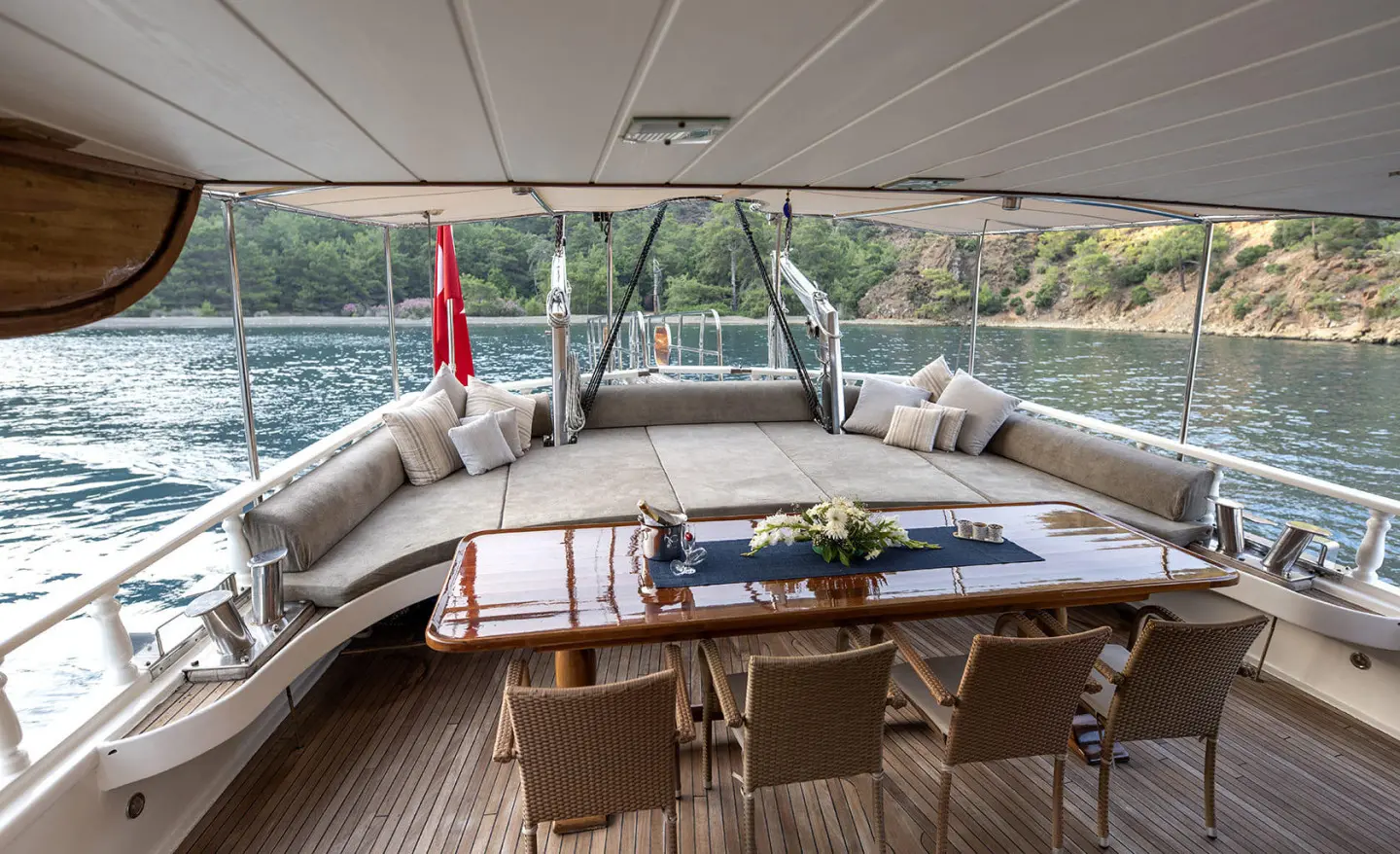 Kayhan 8 yacht interior cockpit with seating and wooden table at sunset