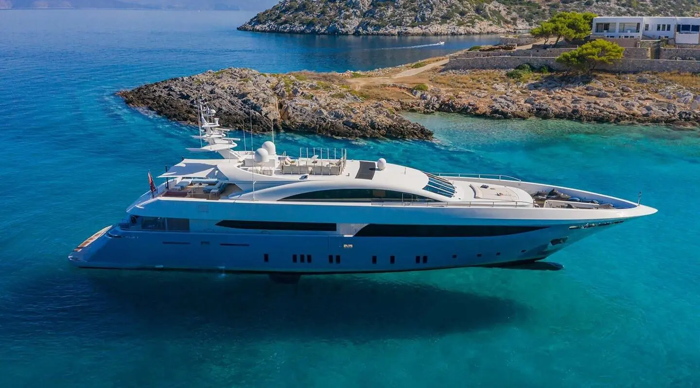 Sea Wolf yacht anchored near rocky coastline with clear blue waters