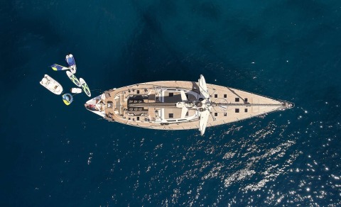 top-down view of Aizu yacht with water toys attached in deep blue sea