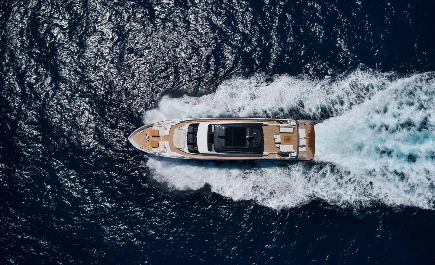 Top-down view of Spica yacht cruising on dark blue open water