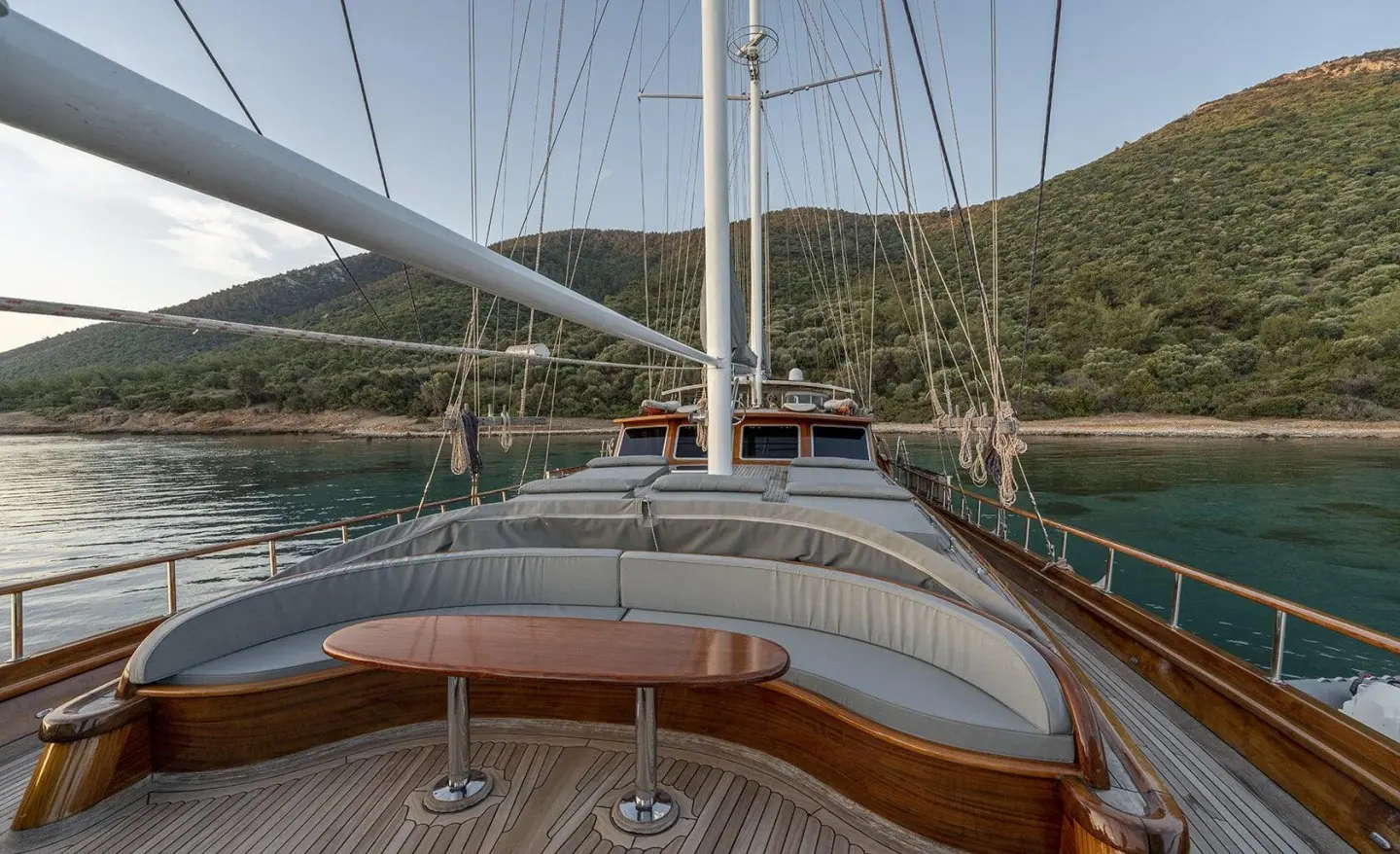 Yacht Bedia Sultan at sunset with rope railings and wooden deck