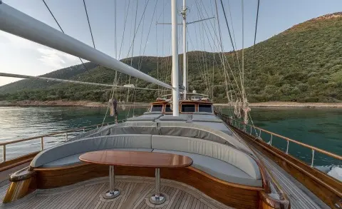 Yacht Bedia Sultan at sunset with rope railings and wooden deck