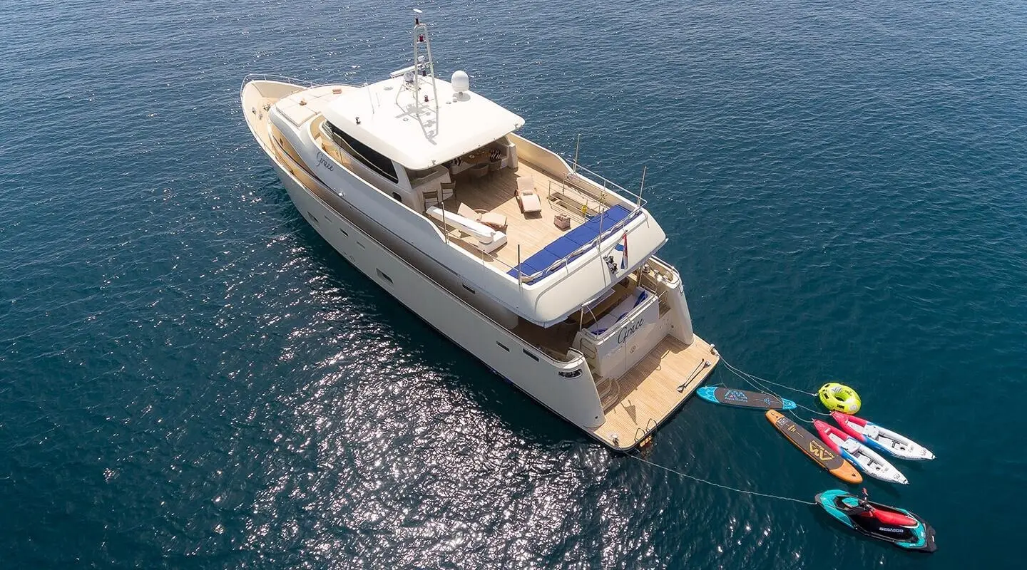 Grace yacht anchored at sea with open sun deck and lounge area
