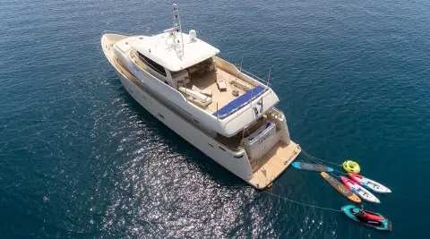 Grace yacht anchored at sea with open sun deck and lounge area