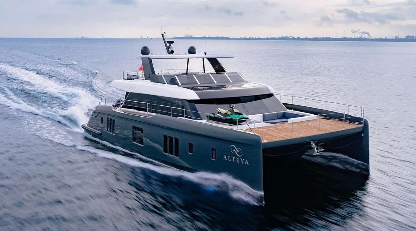 Alteya luxury motor yacht cruising, sleek dark hull, open aft deck and sun loungers