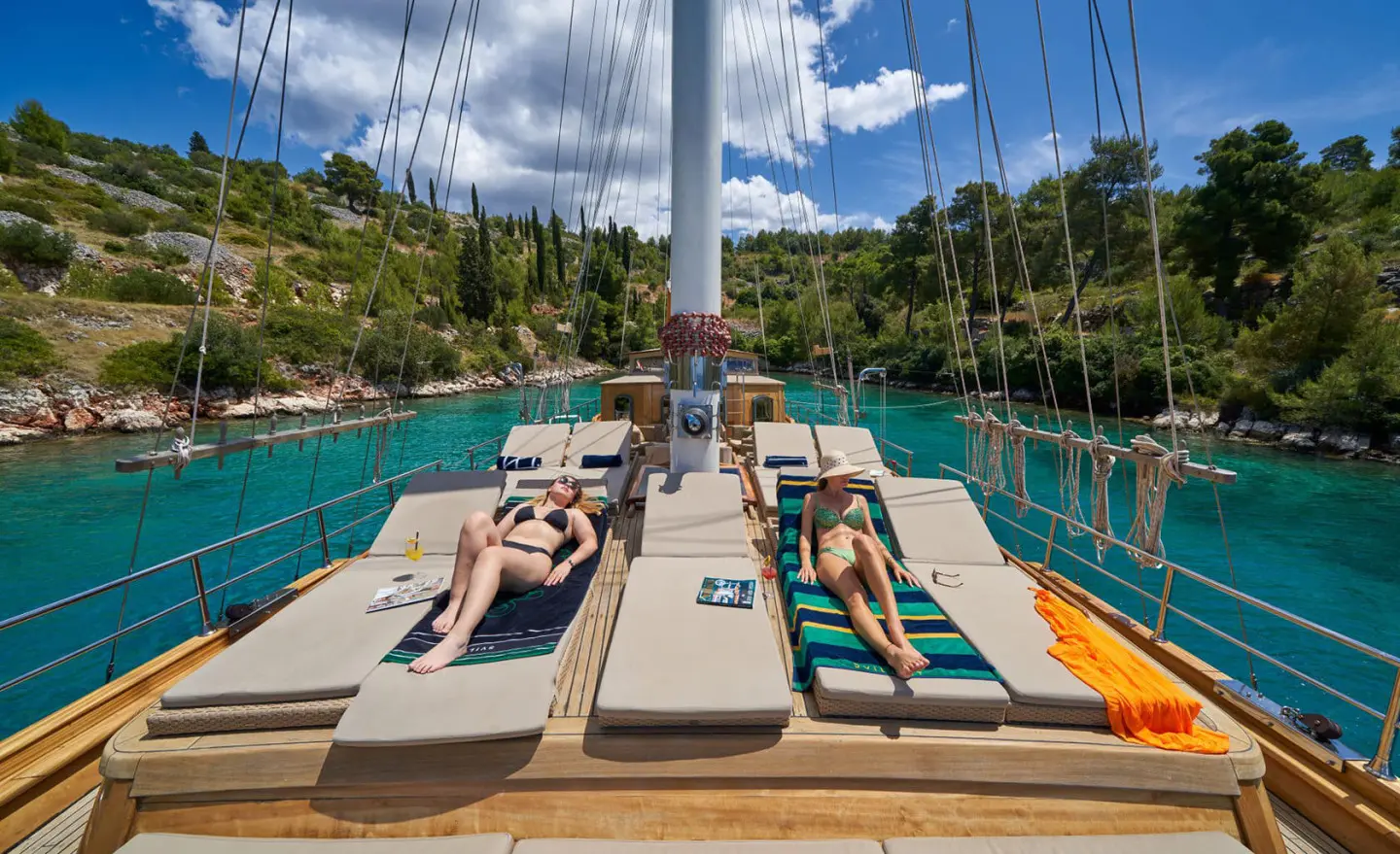 Libra yacht in a poolside deck with sun loungers and blue sky