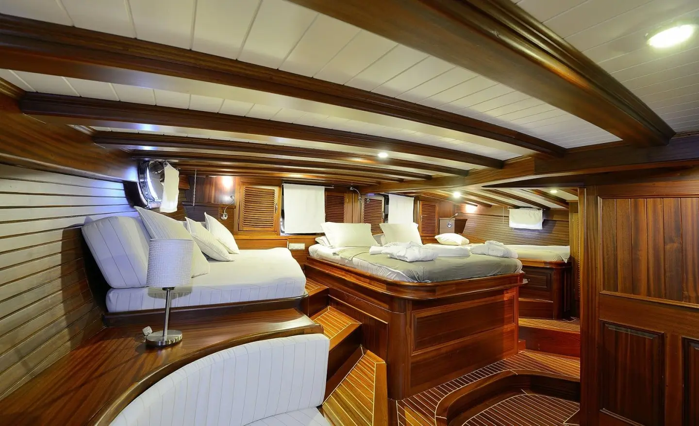 Interior of Zephyria II gulet master cabin with wooden bulkheads and plush seating