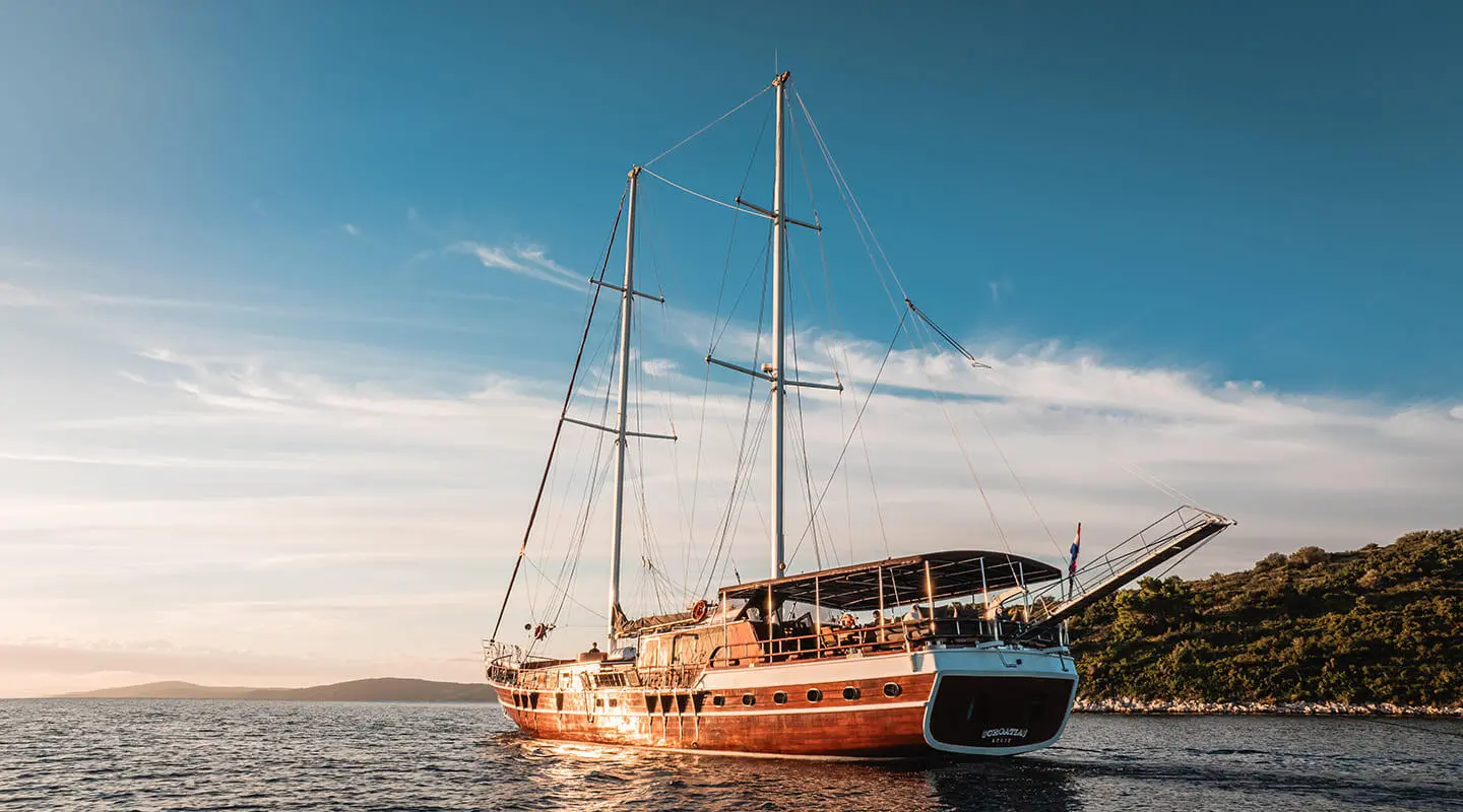 Luxurious sailing yacht anchored near shore at sunset in Croatia