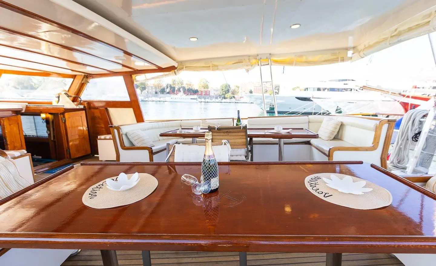 Gardelin yacht charter table setup on deck with sunset view and water