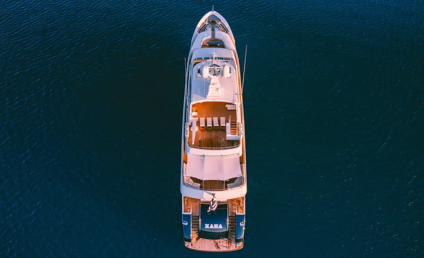 Aerial view of Xana yacht with sun loungers and shaded seating on the deck