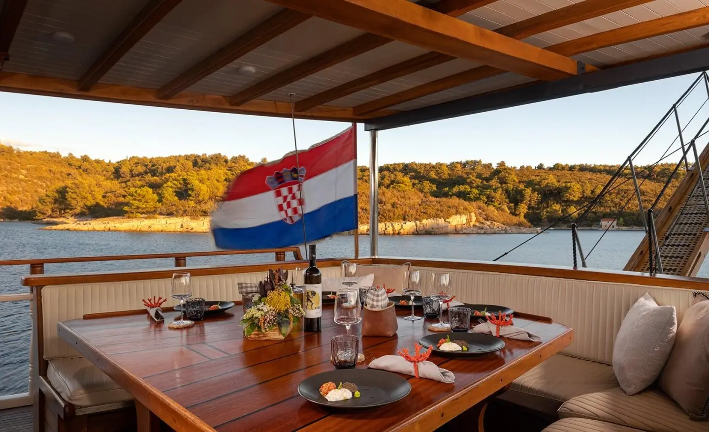 Aborda luxury gulet dining area on deck during sunset with table set