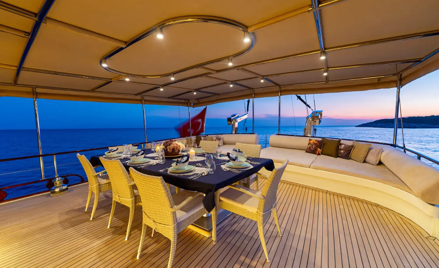 Aft deck of gulet Mein Schatz with seating, table, and sunshade on sunny day