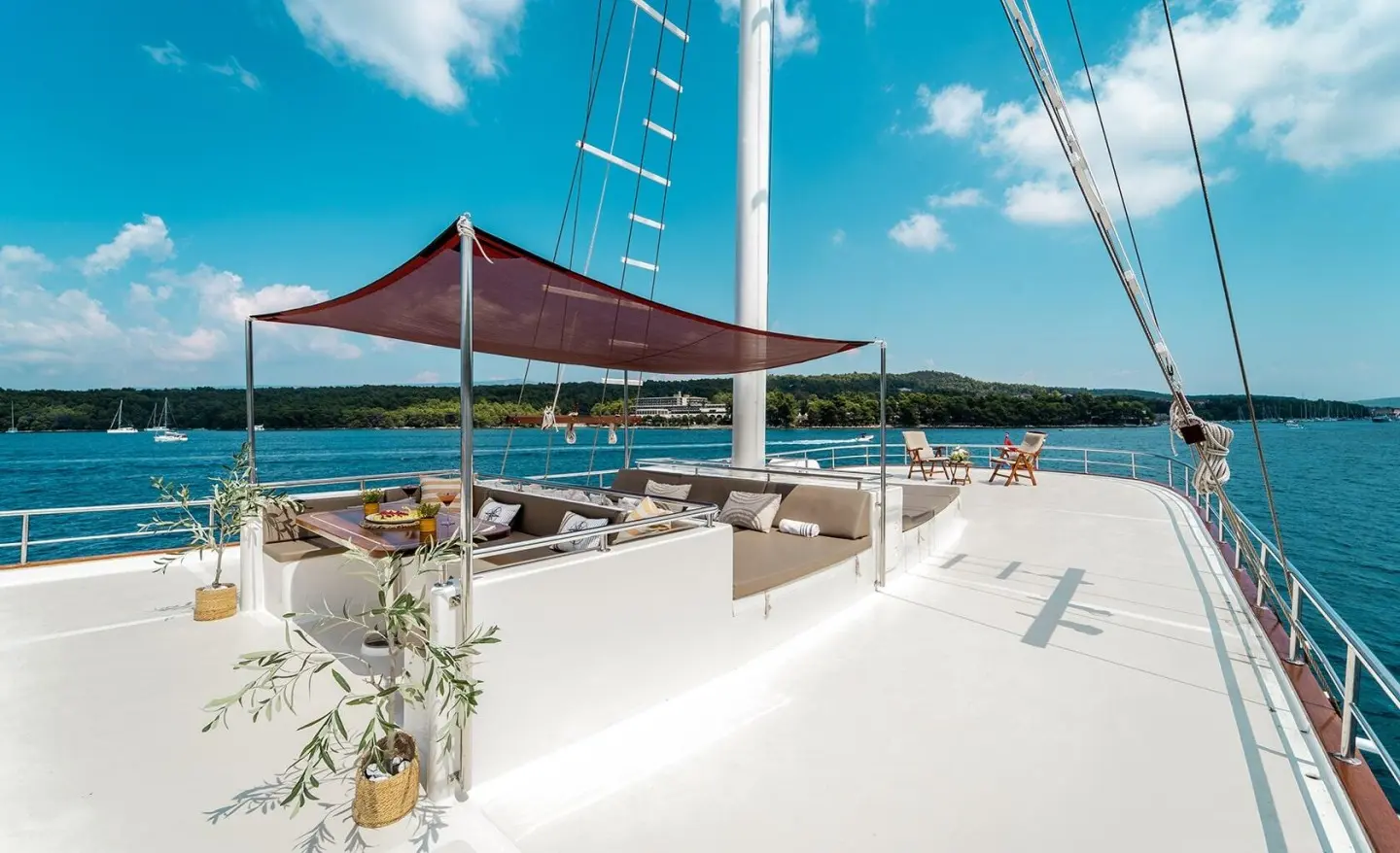 Cesarica luxury gulet at sunset with white deck and blue sails