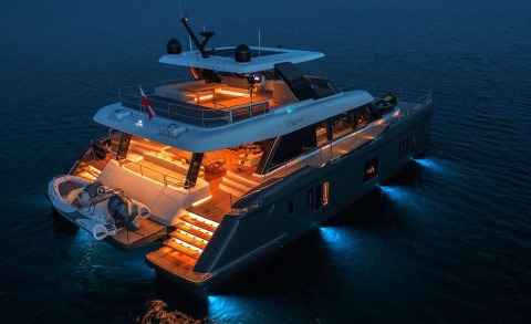 Night-lit yacht Alteya viewed from above, with illuminated decks and blue underwater lights