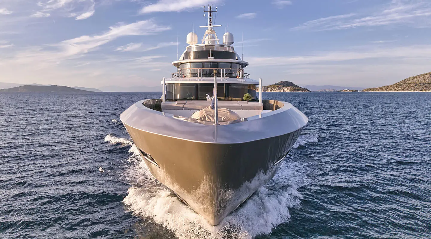 La Pellegrina 1 yacht cruising at sea during sunset, bow toward viewer