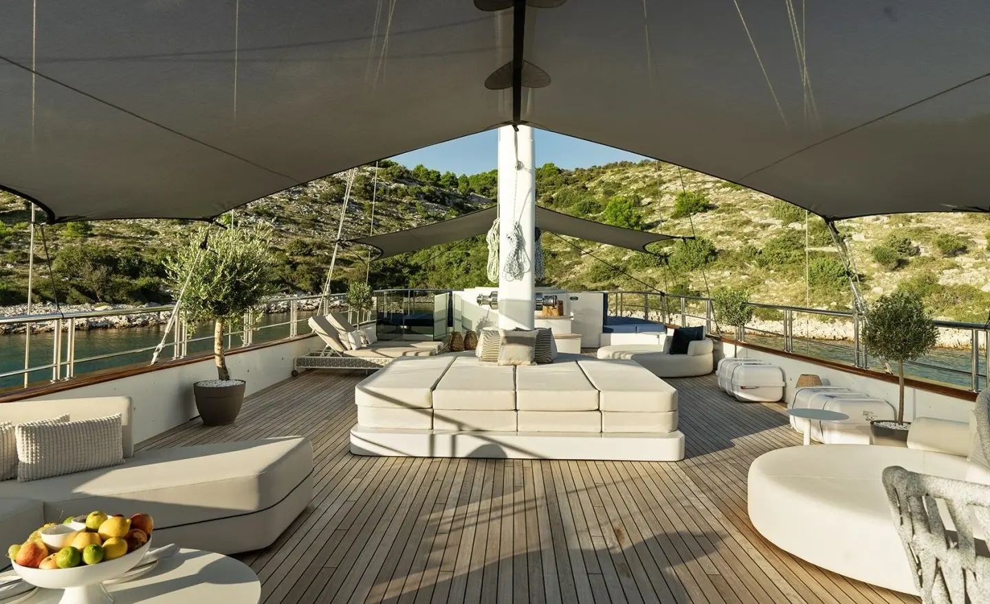 Maxita motoryacht sundeck with seating and shaded area overlooking water