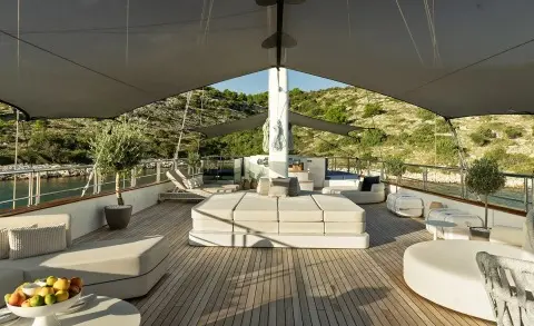 Maxita motoryacht sundeck with seating and shaded area overlooking water
