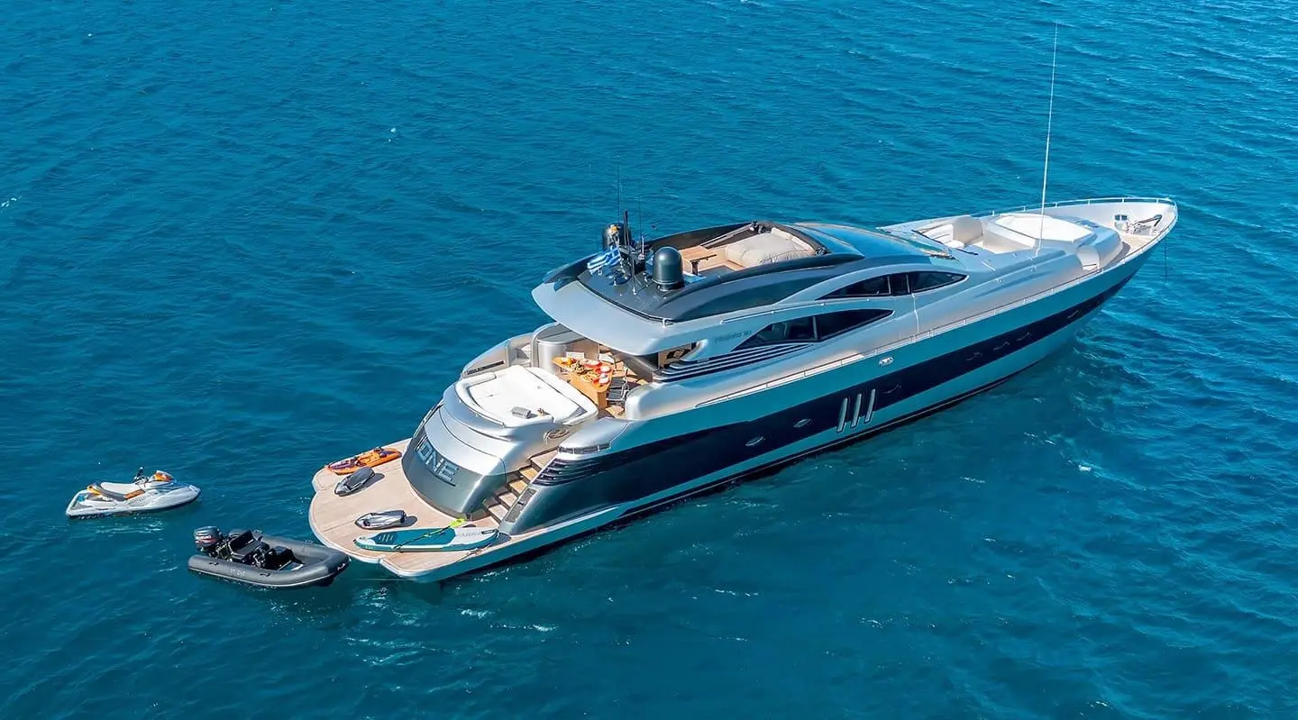 Luxurious motor yacht with open aft deck anchored in blue sea
