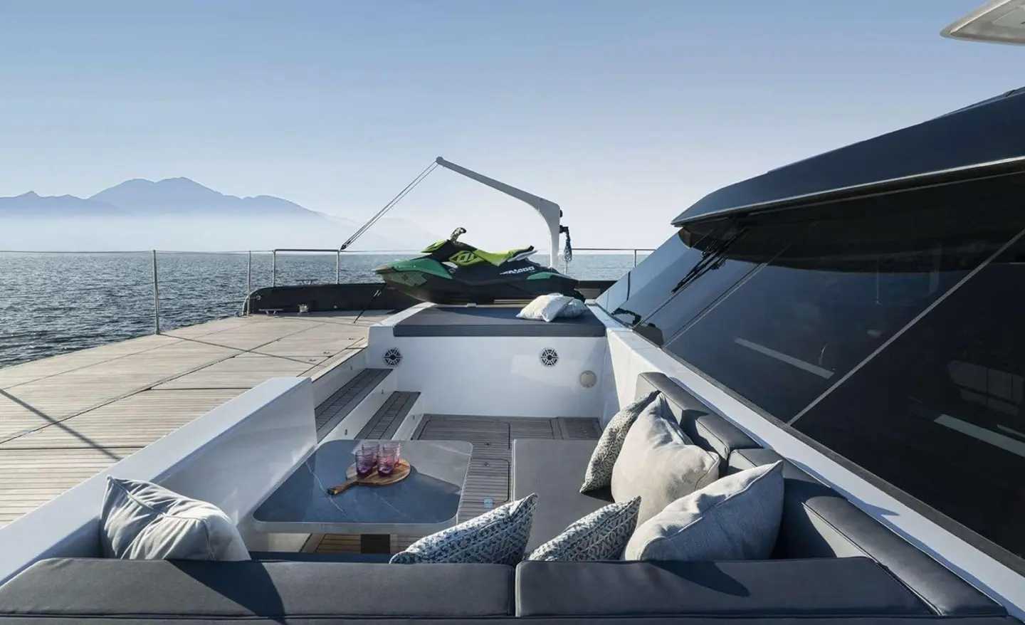 Alteya yacht aft deck with seating, table, and watercraft on swim platform