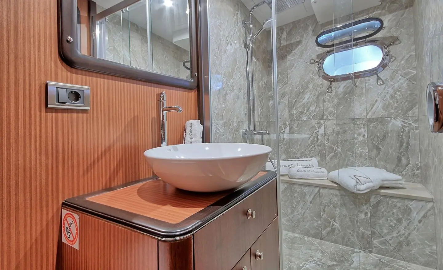 Bathroom of Queen Of Salmakis gulet with sink, wooden cabinet, round vessel basin