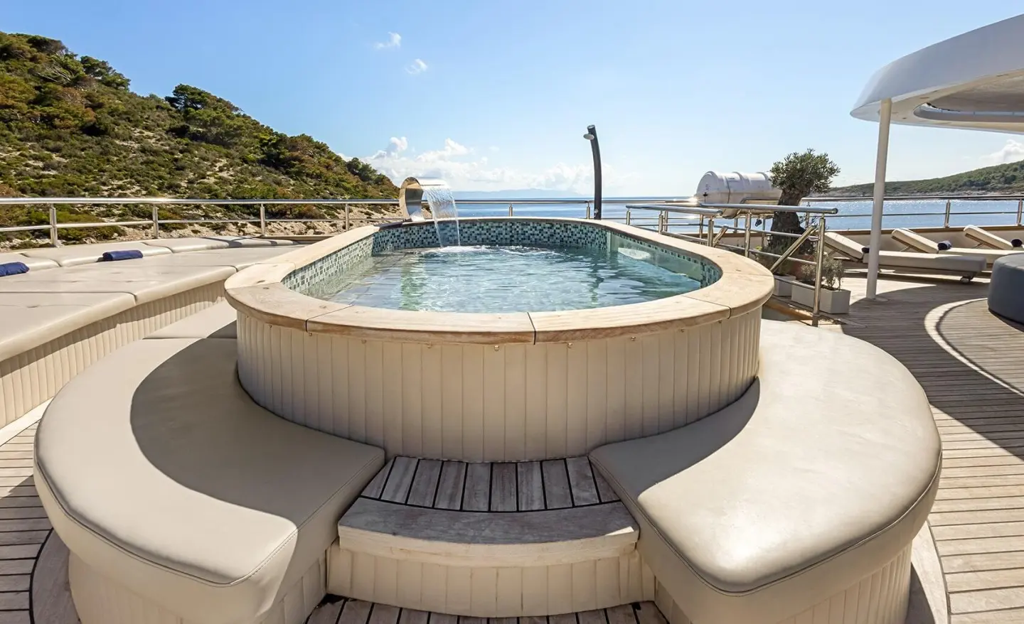 Bella yacht deck with circular hot tub and steps leading down