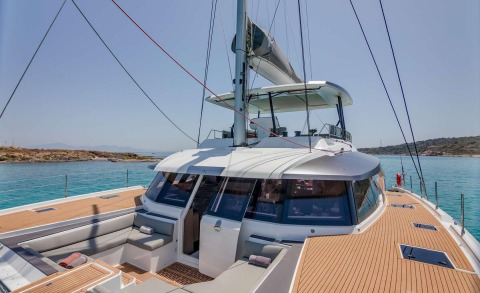 Astoria yacht bow deck and cockpit on sunny sea, teak-laid deck and upscale seating